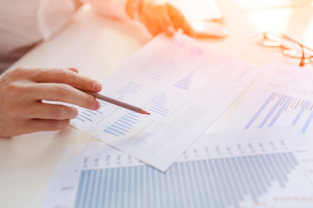 Financial advisor pointing a pencil at charts while reviewing beneficiary designations